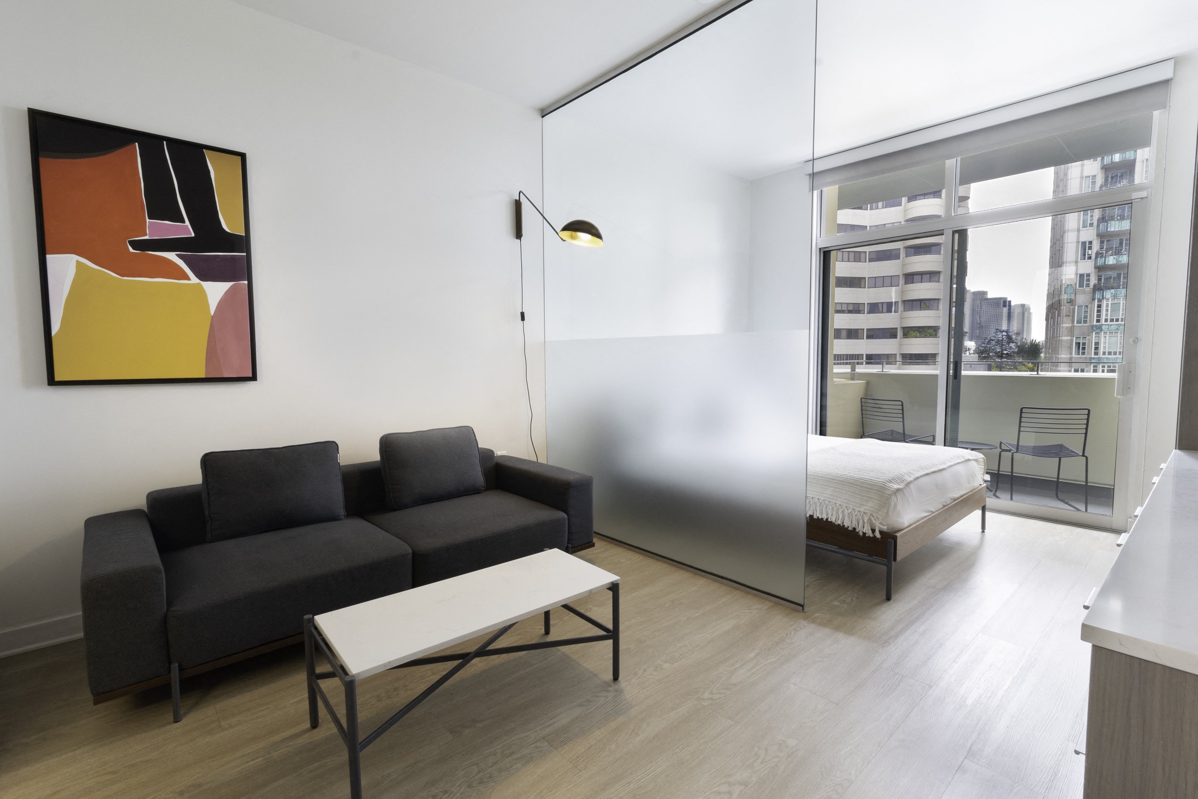 a bedroom with a bed and a couch in a room